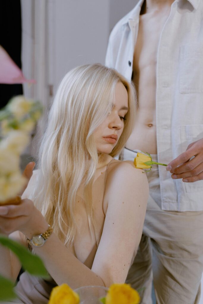 Sensual moment of a couple with yellow roses, embodying romance, elegance, and beauty.